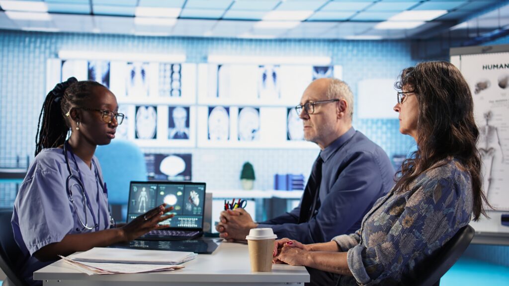 nurse and patients reviewing diagnostic results in medical cabinet